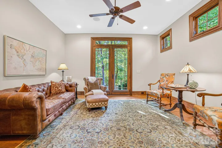 The study/flex room is located near the primary bedroom and includes French doors to an exterior front patio which allows for enjoying the natural surroundings. A walk-in closet can be used for additional storage. In the hallway, a large closet with shelving is perfect for office supplies and wrapping paper.