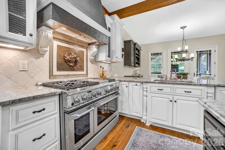 Extensive cabinetry includes an appliance garage, two lazy Susan cabinets, & specialty pull-out drawers.