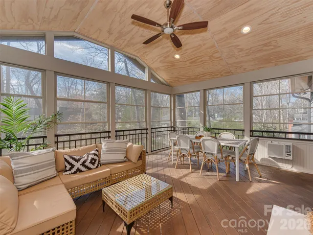 Soak in the beauty of this stunning, four season room, perfectly designed for year-round enjoyment. With walls of windows that invite in natural light and frame peaceful outdoor views, this retreat offers a warm, airy feel with rich wood tones throughout. Conveniently located just off both the primary suite and the living room, it’s an ideal space for morning coffee, quiet relaxation, or effortless entertaining in every season.