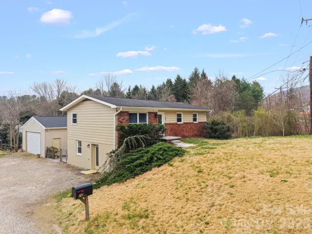 Front view of home showcasing large detached garage.