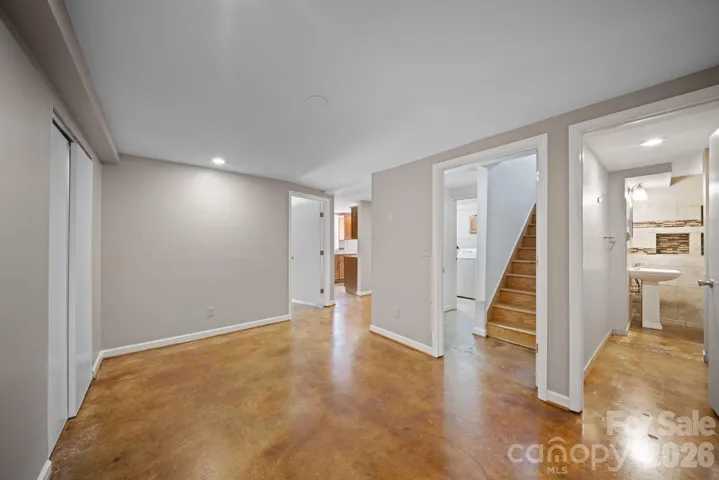 Lower level view from living room looking toward kitchen.