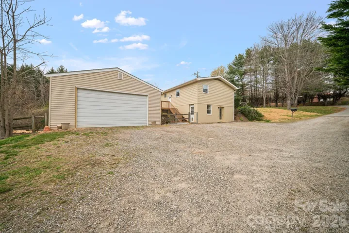 View shows large parking area and detached truck size garage/work shop.