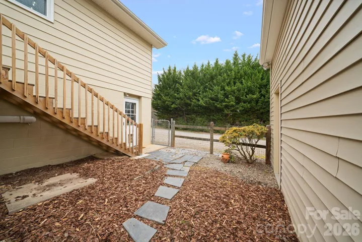 Walkway leading into fully fenced back yard.