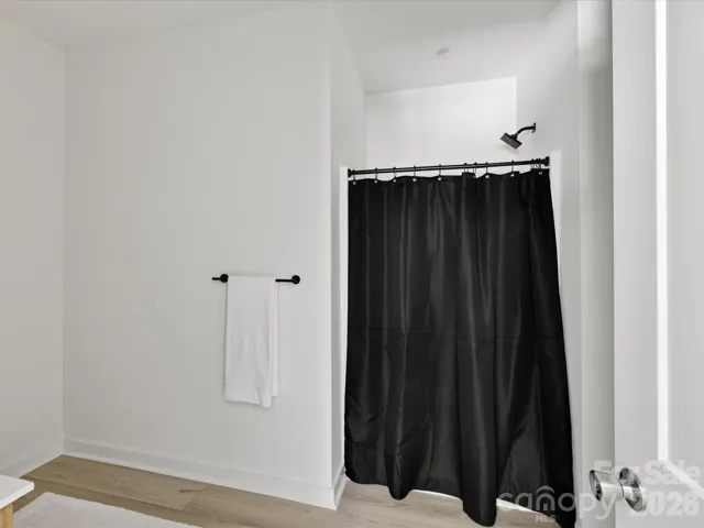 Primary bath shower with modern fixtures and a clean, minimalist design offering a relaxing retreat.
