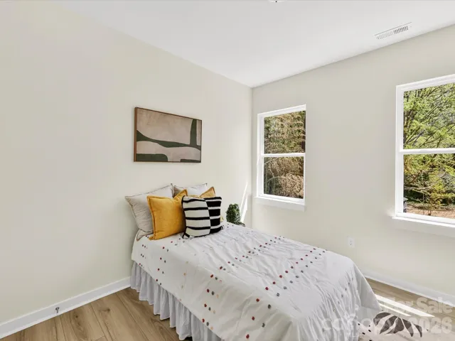 Cozy secondary bedroom filled with natural light, featuring neutral tones and a flexible layout ideal for guests, a home office, or additional living space.