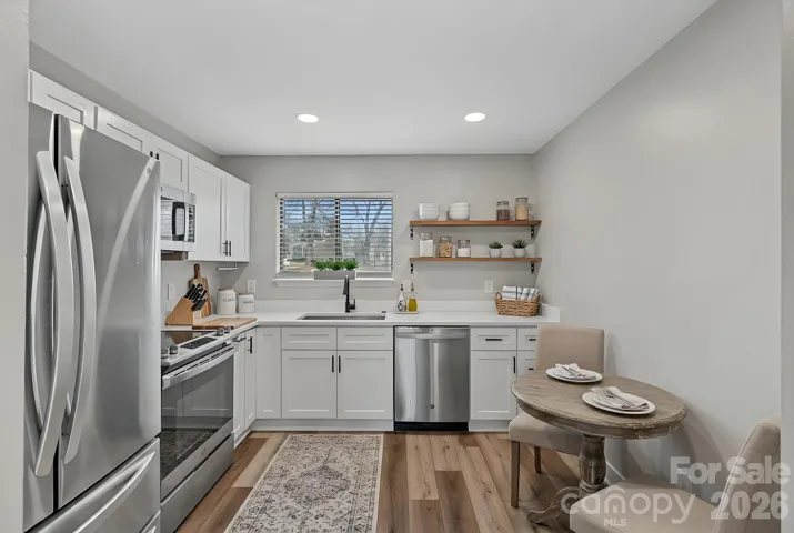 Updated kitchen with quartz, all new cabinetry and stainless steel appliances.  Virtually staged