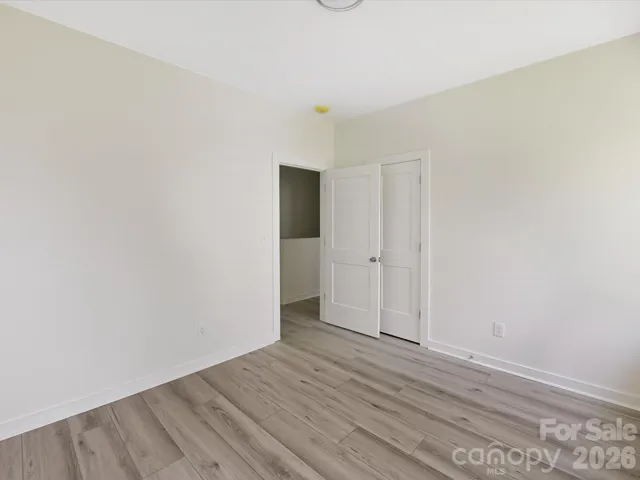 Spacious secondary bedroom features great natural light and a flexible layout, ideal for use as a guest room, home office, or cozy personal retreat.