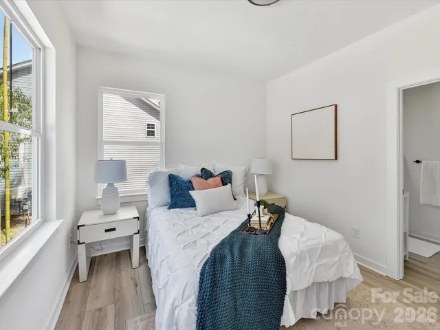 Bright and airy primary suite featuring a spacious bedroom, modern ensuite bathroom with sleek finishes, and a large walk-in closet for ample storage.