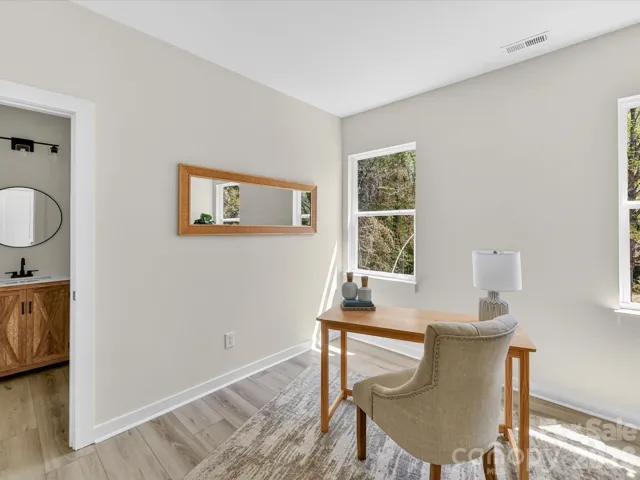 Versatile secondary bedroom offers the perfect space for a private home office or comfortable guest retreat, with ample natural light and a functional layout.