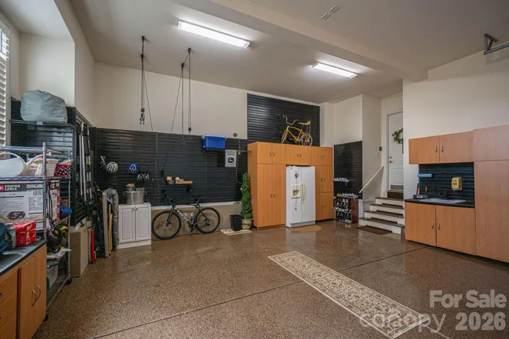 2 of 3 car garage with epoxy flooring/built in cabinets