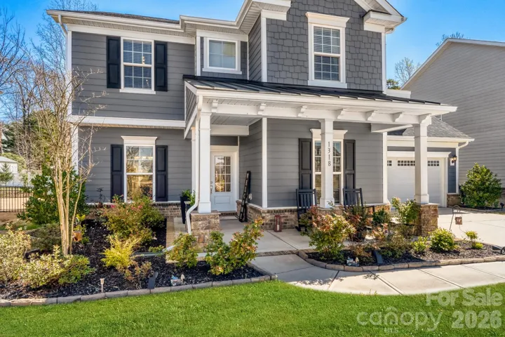 Beautiful front entry with rocking chair front porch.