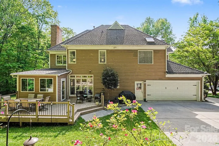 Rear exterior with deck and enclosed sunroom