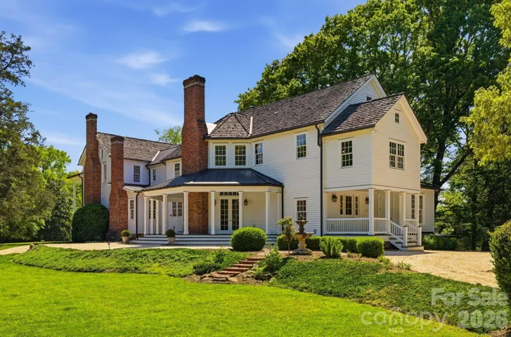 Thoughtfully restored historic residence blending original character with modern luxury, surrounded by mature landscaping and exceptional privacy