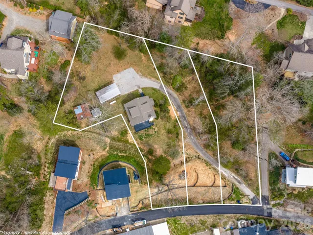 3/1 home with 2 buildable lots one block from Beaver Lake in North Asheville. Lot lines are estimated and not a survey.
