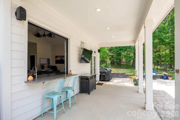 Indoor/outdoor bar on pool house covered porch