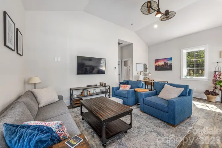 Rec room features a vault ceiling and powerful fan for summer gatherings.