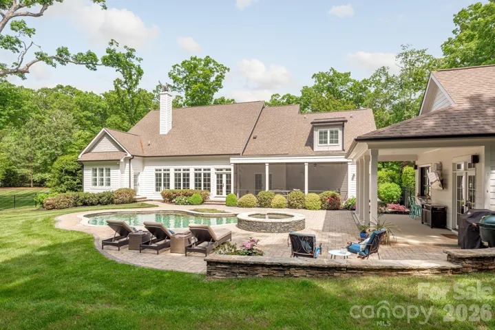 Rear of home with covered pool house porch and screen porch