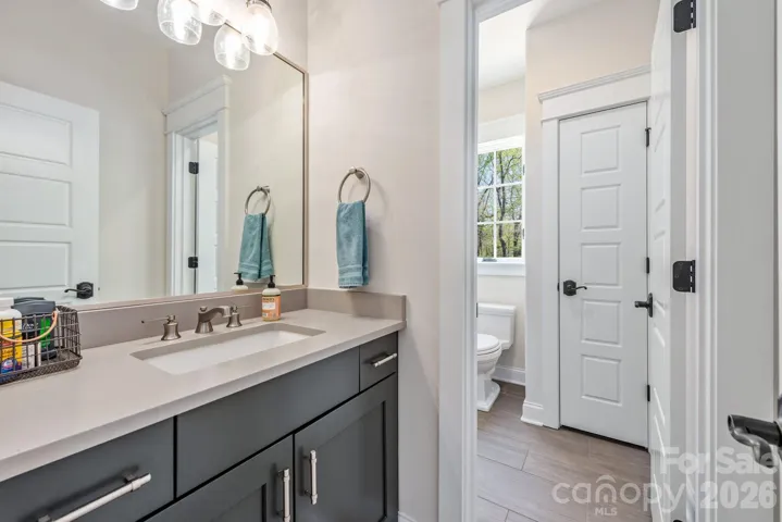 Private vanity area into shared bath