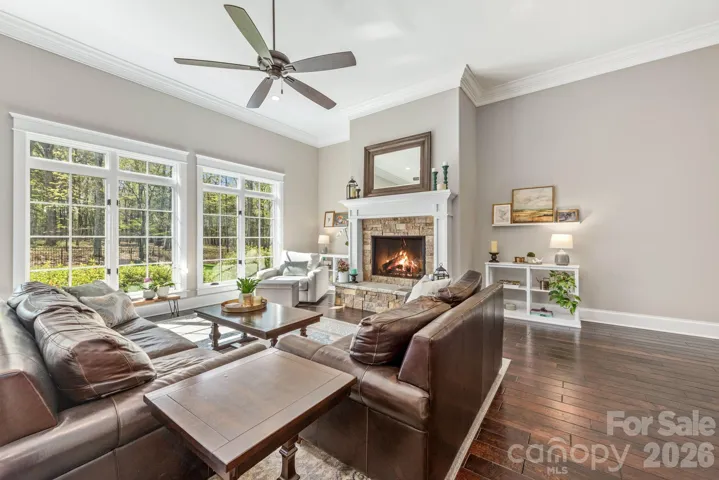 Great room includes stunning gas fireplace and oversized windows to enjoy the private backyard