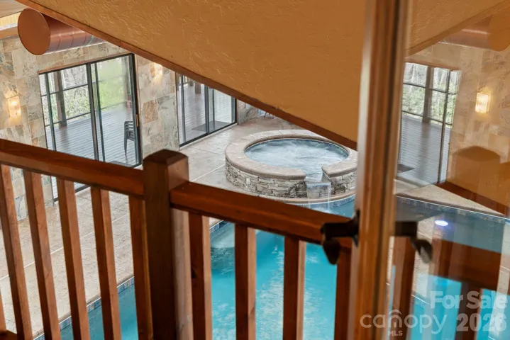 view from primary down to indoor pool/spa via private door and stairs
