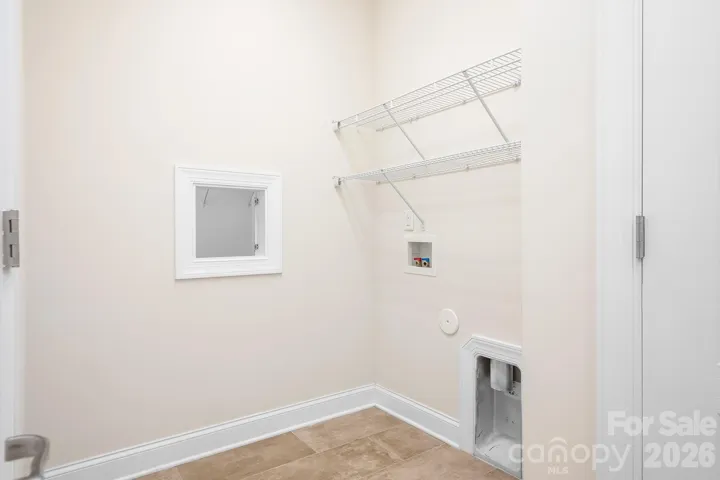 laundry room with laundry shoot from primary closet