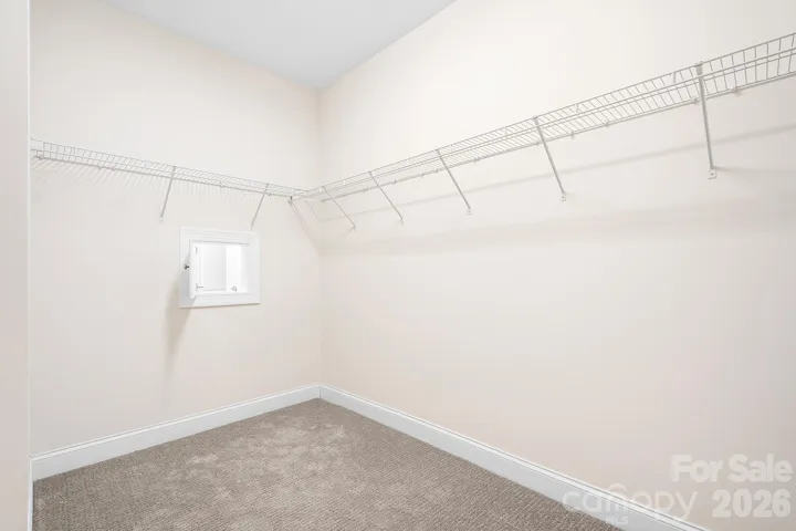 Walk in closet with laundry chute