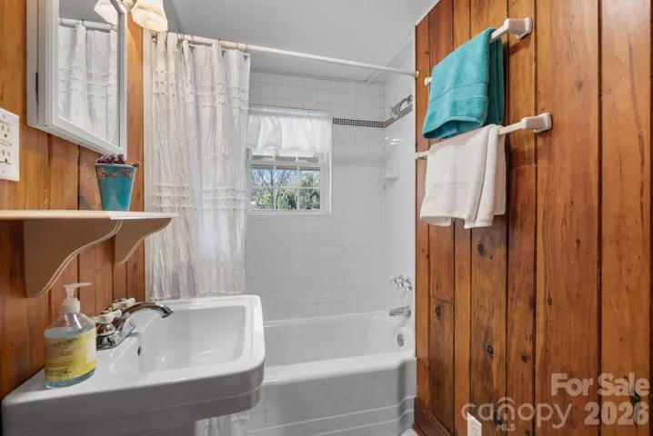 Secondary bathroom features a tub / shower combination