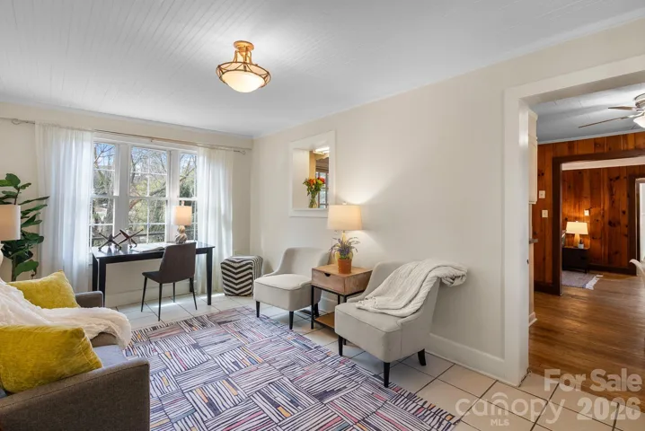 Ceramic tiling from foyer area leads to wood floors in kitchen, dining and living room