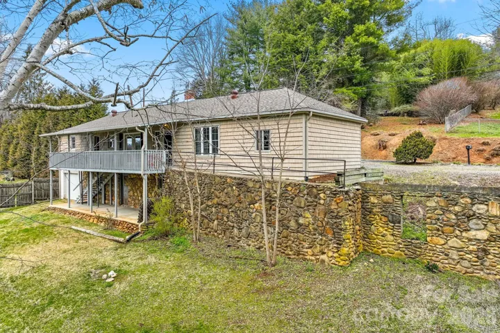 The other garage flanks the other end of the home and it is accessed from Holtzclaw Street