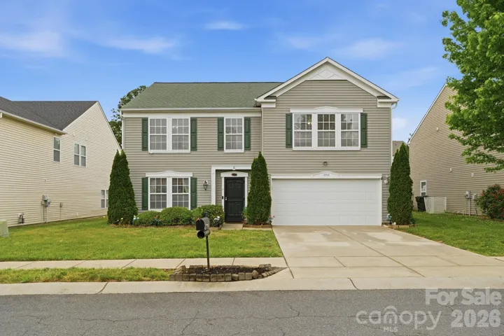 Beautiful front exterior with mature landscaping