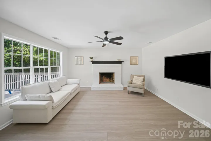 Spacious Family Room with wood burning fireplace. Backdoor leads to oversized deck.