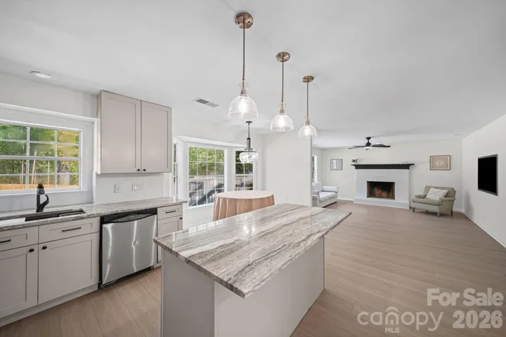 Fully updated kitchen features 42" cabinets and beautiful countertop with a large island and breakfast area.