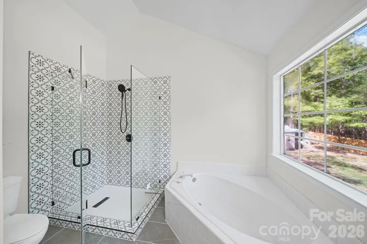 Tiled shower including the floor, no plastic inserts here! Plus a beautiful glass enclosure