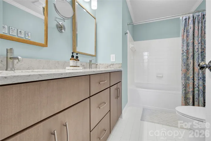 Primary Bathroom with dual sinks and shower/tub.
