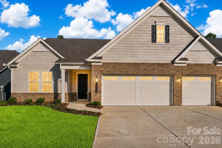 Beautiful curb appeal welcomes you home, featuring a 3-car garage, attractive brick and siding exterior, covered entry, and low-maintenance landscaping.