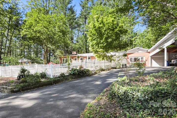Recently refinished driveway leads to the carport, shop (unheated), and ramped entrance to deck