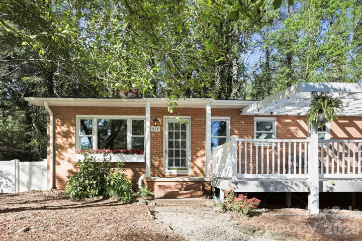 Front door and walkway through low-maintenance, fenced front yard