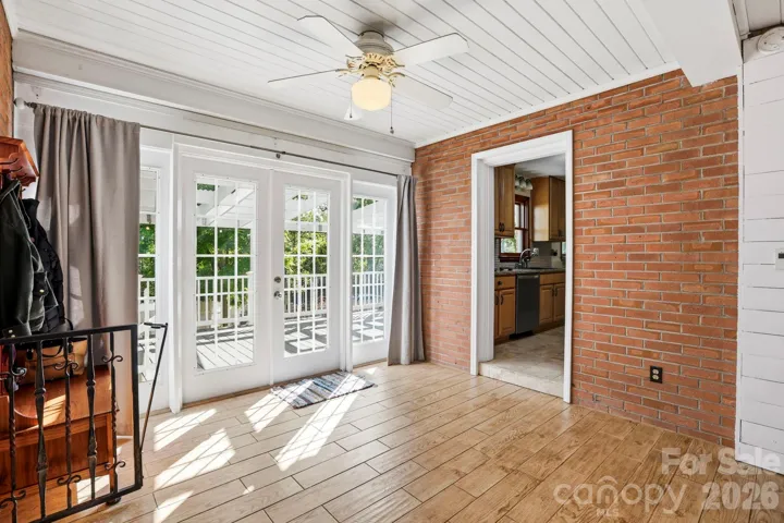 French doors lead into a space that can work as a breakfast area, mudroom, an office, or storage!