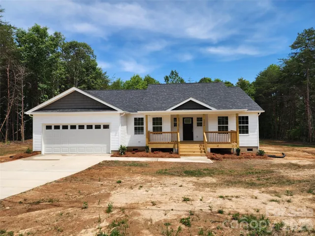 Front Elev w/Large covered Porch, 2 Car Garage and Decorative Landscaping