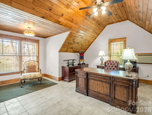 The upper level (over garage) bedroom or office provide privacy and a full bathroom.