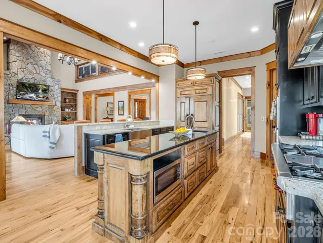 Chef's kitchen includes Wolf six burner gas range with pot filler, Wolf double ovens, Sub-Zero refrigerator, wine cooler, Bosch dishwasher and built-in microwave.