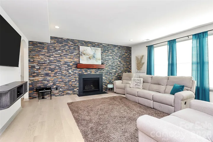 family room with gas fireplace and stunning accent wall