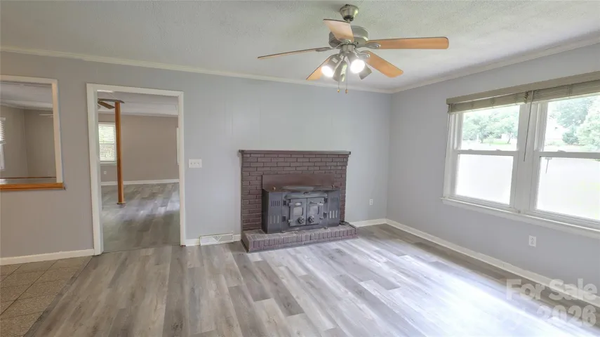 Brand new LVP flooring throughout Dining room with wood burning fireplace