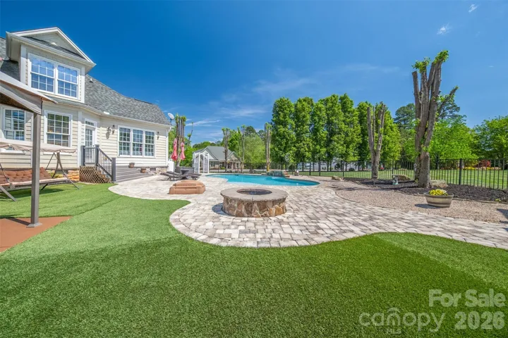 Fire pit with turf around pool area