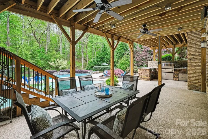 Basement covered patio with dining area and outdoor kitchen