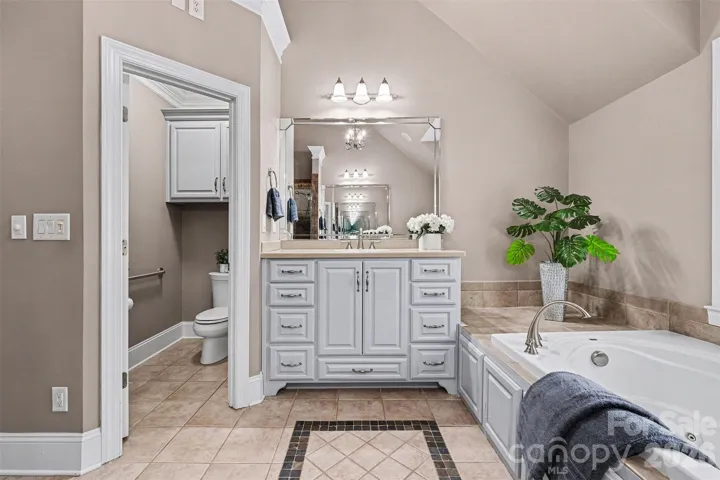 Primary spa bathroom with double vanities, shower and garden tub