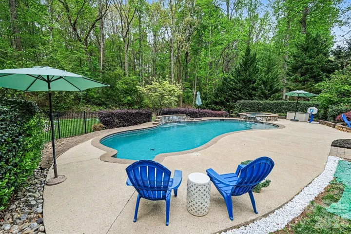 Magnificent back yard with multiple areas to entertain and enjoy: pool, spa, fire pit, patio, covered porch