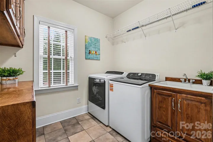 Laundry room with ample cabinet space and folding table.