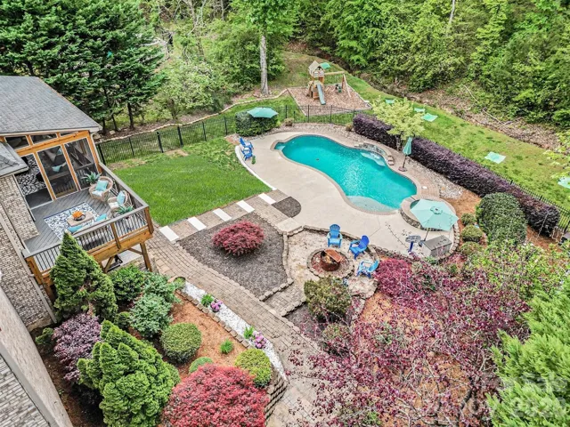 Magnificent back yard with multiple areas to entertain and enjoy: pool, spa, fire pit, patio, covered porch