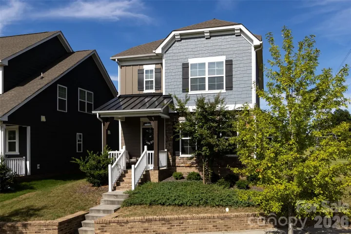 Welcome Home! Charming curb appeal with a welcoming front porch, stylish exterior finishes, and beautifully landscaped yard.